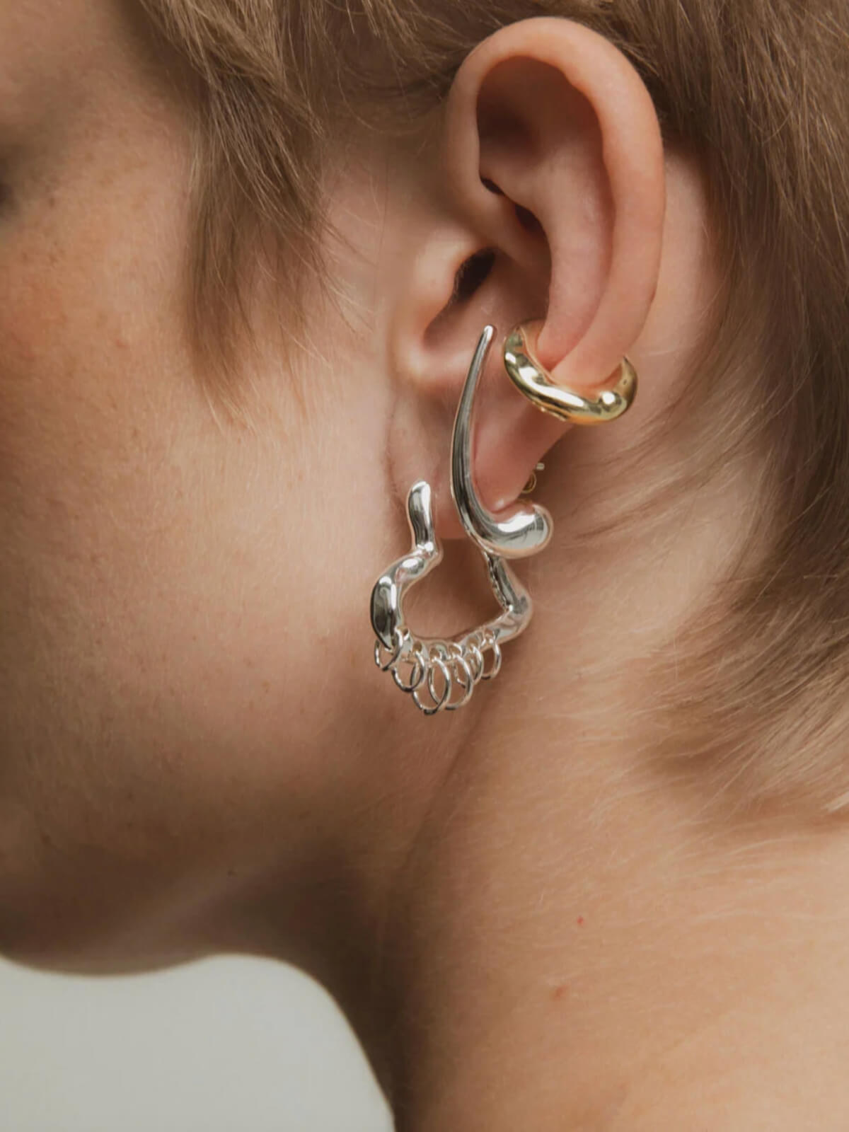 Tough Love Pierced Heart Hoop Earrings: Silver - 25mm