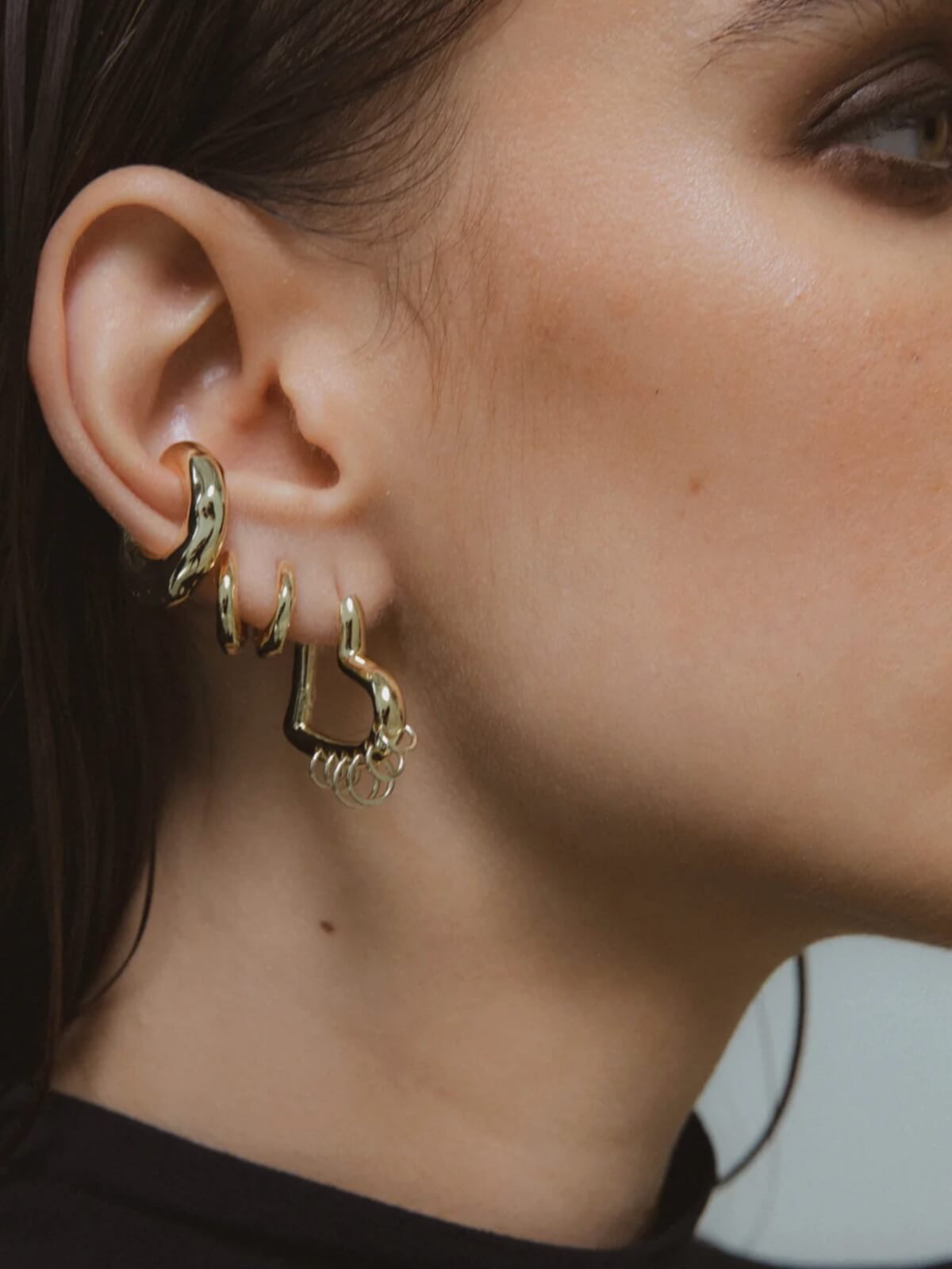 Tough Love Pierced Heart Hoop Earrings: Gold - 25mm